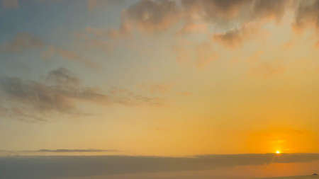 Beautiful cloudy sunset landscape with sun