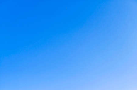 Beautiful blue sky background with tiny cloudsの写真素材