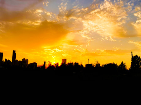 Beautiful cloudy sunset landscape with sunの写真素材