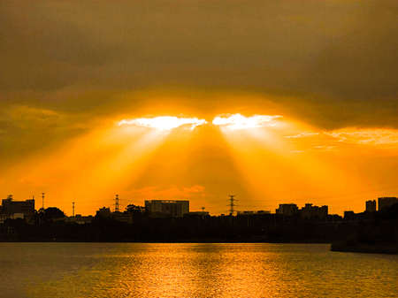 Beautiful cloudy sunset landscape with sun