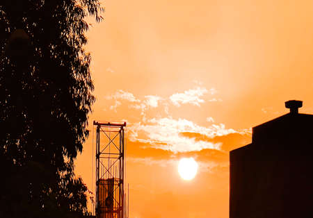 Beautiful cloudy sunset landscape with sunの写真素材