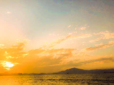 Beautiful cloudy sunset landscape with sun