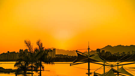 Beautiful cloudy sunset landscape with sunの写真素材