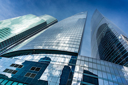 A Moscow city skyline with a tall building in the middle in Moscow Russia. The sky is blue and there...