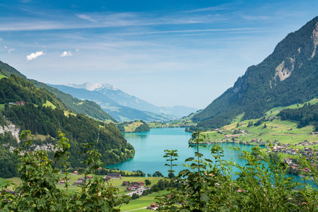 A beautiful mountain valley on Lungerersee in Swiss from a viewpoint. The lake is blue and the mountains are in the backgroundの写真素材