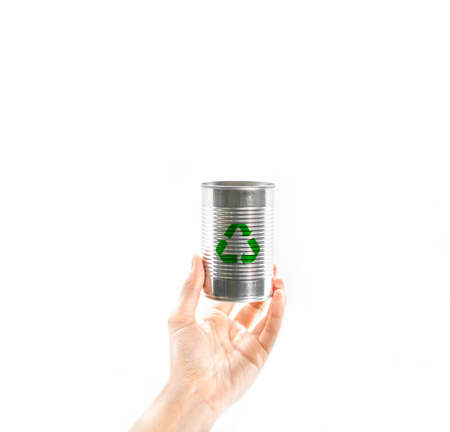 Personâs hand hold an empty grey aluminum food container with green recycle symbol on white background. Concept of care, responsible, recycling and save the environment and world from global warming.の写真素材