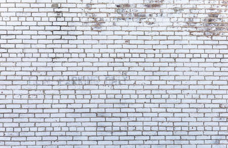 Exterior white ancient brick wall, rough surface and unique pattern material for building. Aged with...