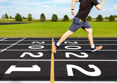 New year concept with motion blurred of man running overcome year 2021 to 2022 at black running track, selective focus on numbers. Ideas of passing old year to new year. Racing and success conceptual.の写真素材