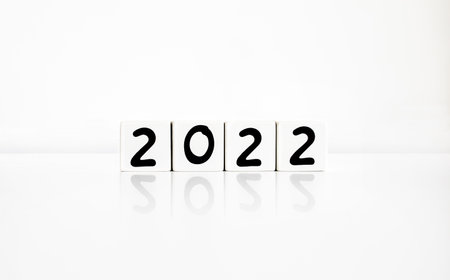 Cubic of 2022 with a reflection on white background. Minimal new year concept with copy space. Beginning of the year, simple black typography on cubes.の写真素材
