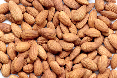 Background of big raw peeled almonds situated arbitrarilyの写真素材