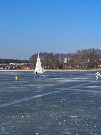 Wind sailing on a frozen lake in the city parkの写真素材