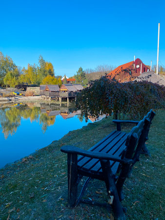 Wooden bench on the bank of the river in the village.の写真素材