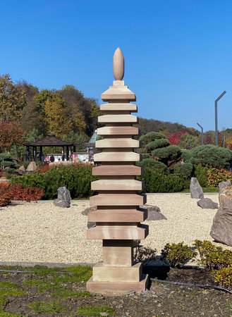 Japanese garden with a sculpture of a towerの写真素材