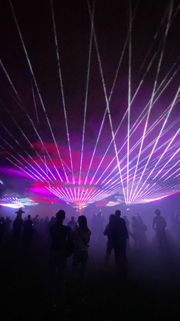 People enjoying laser show at night. Colorful laser show.の写真素材