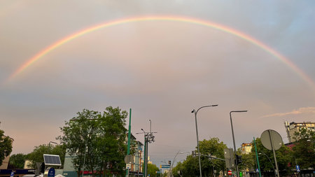 Rainbow over the city, cloudy skyの写真素材