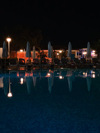 Swimming pool at night in the village of Turkeyの写真素材