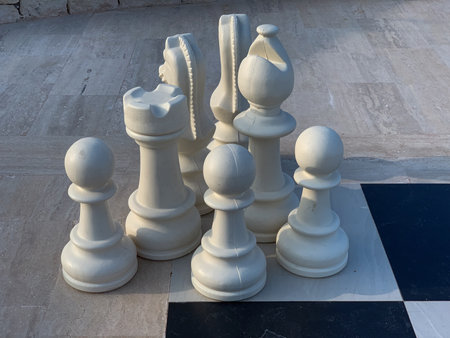 Chess pieces on the marble floor, closeup of photo.の写真素材