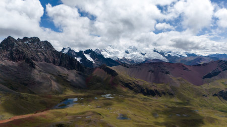 Aerial drone Rainbow Mountain Vinicunca in Peru Andes colourful striped landscape mountains south america