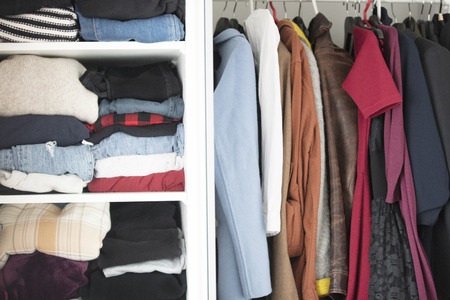 photo of beautiful modern woman wardrobe full of clothes close up