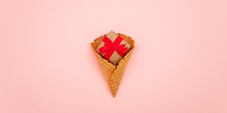 photo of cute gift in waffle cone on the wonderful pink studio backgroundの写真素材