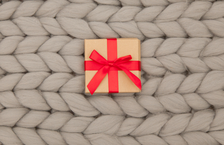 photo of cute gift on the wonderful warm grey blanket backgroundの写真素材