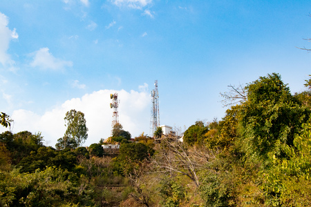High voltage tower, electric transmission tower in hill area. Electricity distribution tower on top...