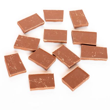 Milk chocolate pieces isolated on white background from top side view