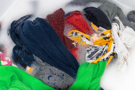 Soaking color clothes in washing powder, household choresの写真素材