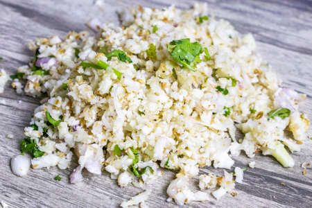 Raw cauliflower rice or grated raw cauliflower. Gobi paratha staffing with onion and coriander...