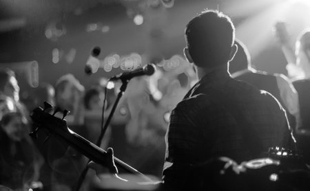 Band performing live on stage, close-up view of hands.