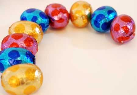 close-up of colorful small eggs against white background for your easter design の写真素材