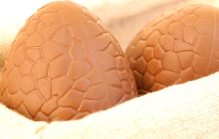 extreme close-up of chocolate egg in basket against white background  の写真素材