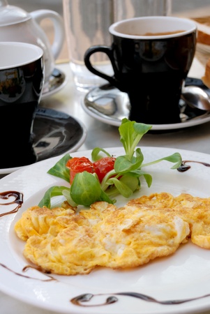 isolated omelet on white plate with little tomatoes for decoration の写真素材