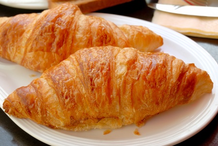 two isolated croissants in white plateの写真素材