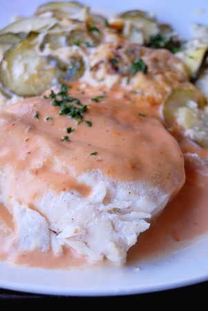 fillet of fish with sauce and vegetables on background 