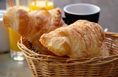 close-up of french breakfast with croissants in basket