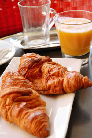 close-up of french breakfast with croissants in white plate and orange juiceの写真素材