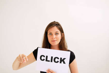 Portrait of young woman holding  click  sign against white background の写真素材