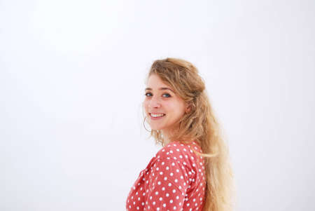 Portrait of young smiling woman against white background の写真素材