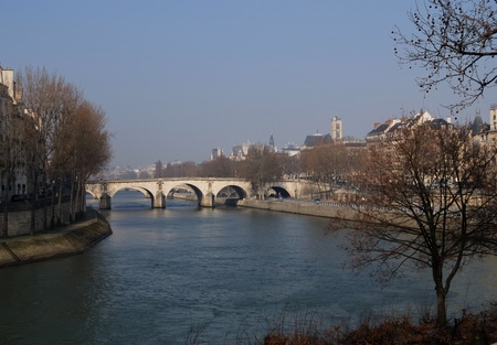 View of the Seine river of Paris  with a medieval bridge in winter の写真素材