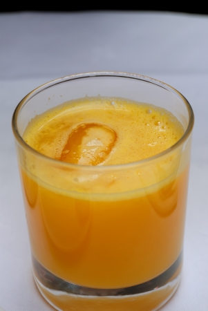 isolated freshorange juice with ice in tableの写真素材