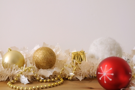 Isolated golden christmas baubles with golden and white ribbons in white backgroundの写真素材