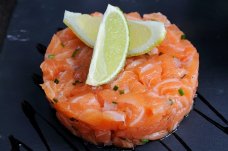 Isolated salmon tartare with lemon の写真素材