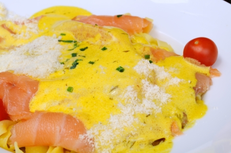 close-up of plate of tagliatelle and salmon with cream sauceの写真素材