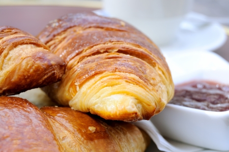 Croissants in white plate with strawberry jamの写真素材