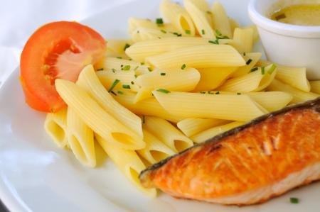 isolated grilled salmon in white plate with pastaの写真素材