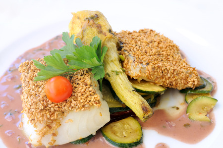 isolated steamed fish with sesame and vegetables