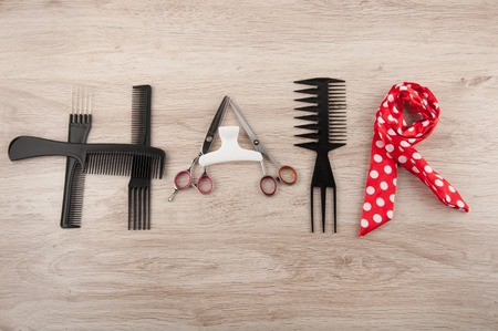 Professional hairdressing acsessories laying on wooden table in word hairの写真素材