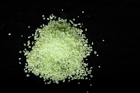 Pile of light green sea salt crystals on black backgroundの写真素材