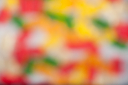 Blurred pattern of different form red, gree, orange, yellow elements on light backgroundの写真素材